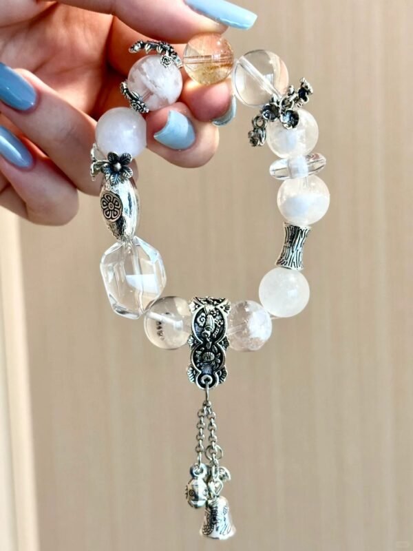 Full view of crystal bracelet! Chiming bell charm + layered silver = next-level gorgeous