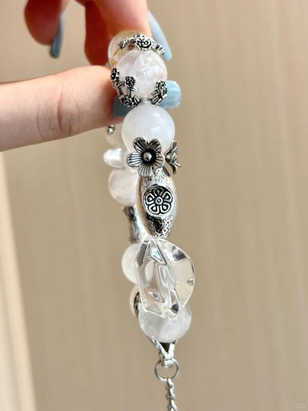 Close-up of icy crystal bracelet! Carved silver charms + faceted crystals glow in light