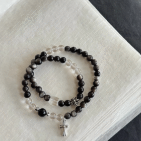 Flatlay of Silver Obsidian & Clear Quartz Double Bracelet, Silver Charms Match, Water-Metal Energy Shows Minimalist Luxury