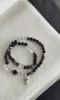 Flatlay of Silver Obsidian & Clear Quartz Double Bracelet, Silver Charms Match, Water-Metal Energy Shows Minimalist Luxury