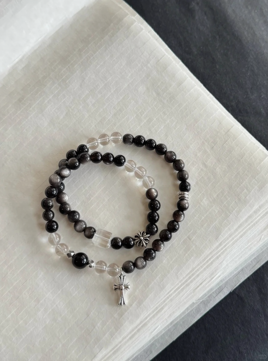 Flatlay of Silver Obsidian & Clear Quartz Double Bracelet, Silver Charms Match, Water-Metal Energy Shows Minimalist Luxury