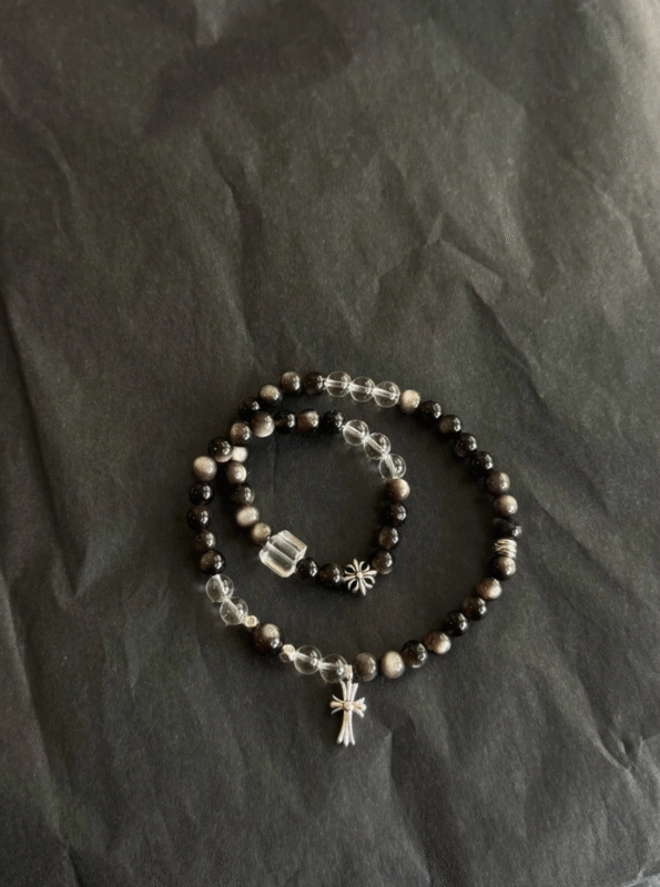 Flat lay of silver obsidian double bracelet! Intricate silver charms, black crystal = instant cool vibe