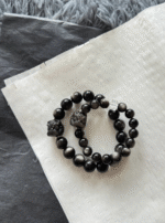 Flatlay of Silver Obsidian Couple Bracelets, Lion Carving & Clear Quartz Accent Match, Water-Metal Energy Shows Chinese Protection Style