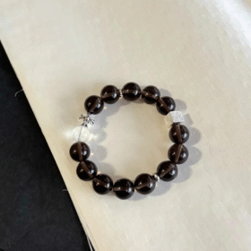 Flatlay of Ice Obsidian Bracelet, Silver Charms Accent, Water-Metal Energy Shows Mystic Calm Style