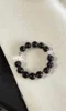 Flatlay of Ice Obsidian Bracelet, Silver Charms Accent, Water-Metal Energy Shows Mystic Calm Style