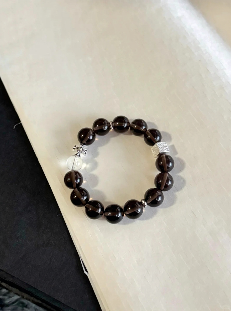 Flatlay of Ice Obsidian Bracelet, Silver Charms Accent, Water-Metal Energy Shows Mystic Calm Style
