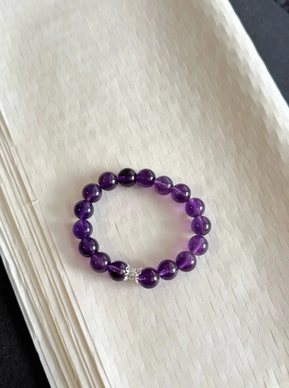 Amethyst on wrist, 10mm beads suiting daily looks, water-element energy clearing brain fog and boosting wisdom