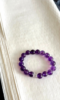 Gradient Uruguayan amethyst bracelet flatlay, deep-purple and light-purple twining silver, water-element energy hidden in luster
