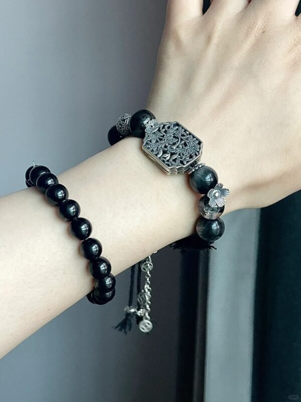 Close-up of bracelet, silver hollow plaque & multi-stone beads, earth-water-metal energy gathering in patterns.