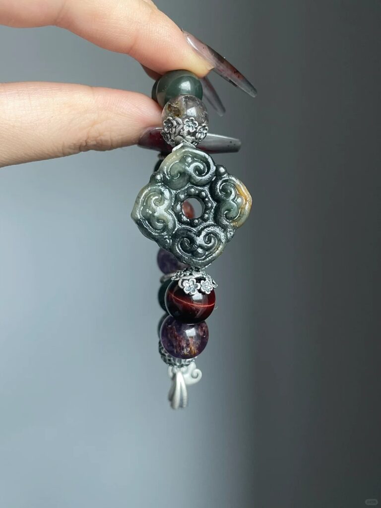Design close-up of Jiangzi bracelet, silver carvings & multi-stones, earth-fire-metal energy in knots