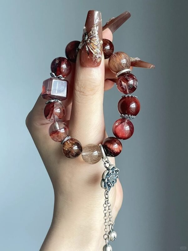 Close-up of red rutile bracelet, red tiger’s eye & silver matching, fire-metal energy in patterns
