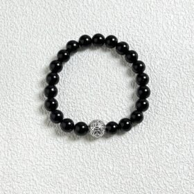 Close-up flatlay of obsidian bracelet, black beads matching silver, water-metal synergy hiding mystery