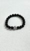 Close-up flatlay of obsidian bracelet, black beads matching silver, water-metal synergy hiding mystery