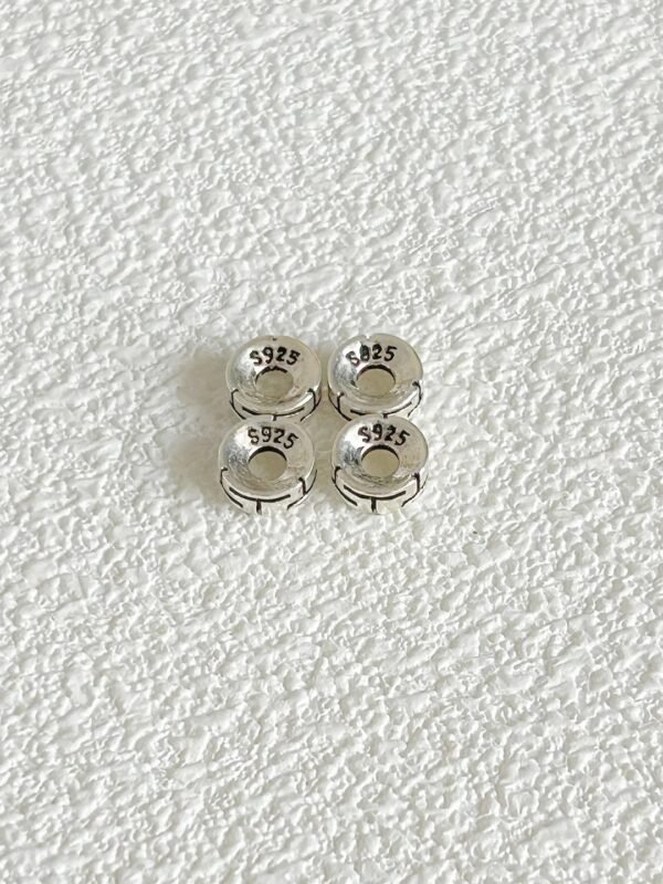 Close-up of S925 silver wave-pattern spacer, vintage design matching water-metal, energy gathered in details