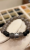Close-up of gray agate bracelet, silver patterns twist with gray-black beads, water-metal energy shows texture