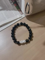 Flatlay of golden obsidian bracelet, 999 silver pixiu in center, water-metal energy locks wealth