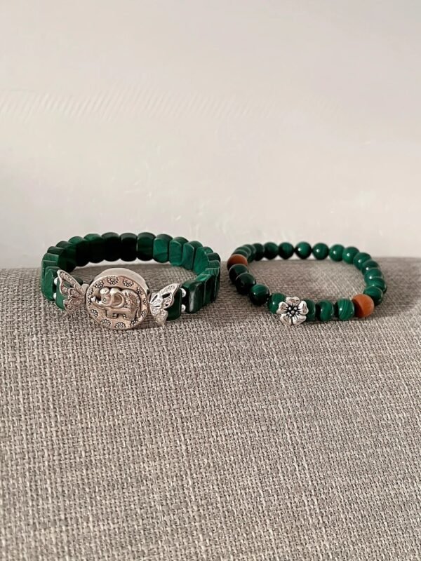 Flatlay of malachite double-strand, silver elephant & red agate match, wood-fire-metal energy shows style layers