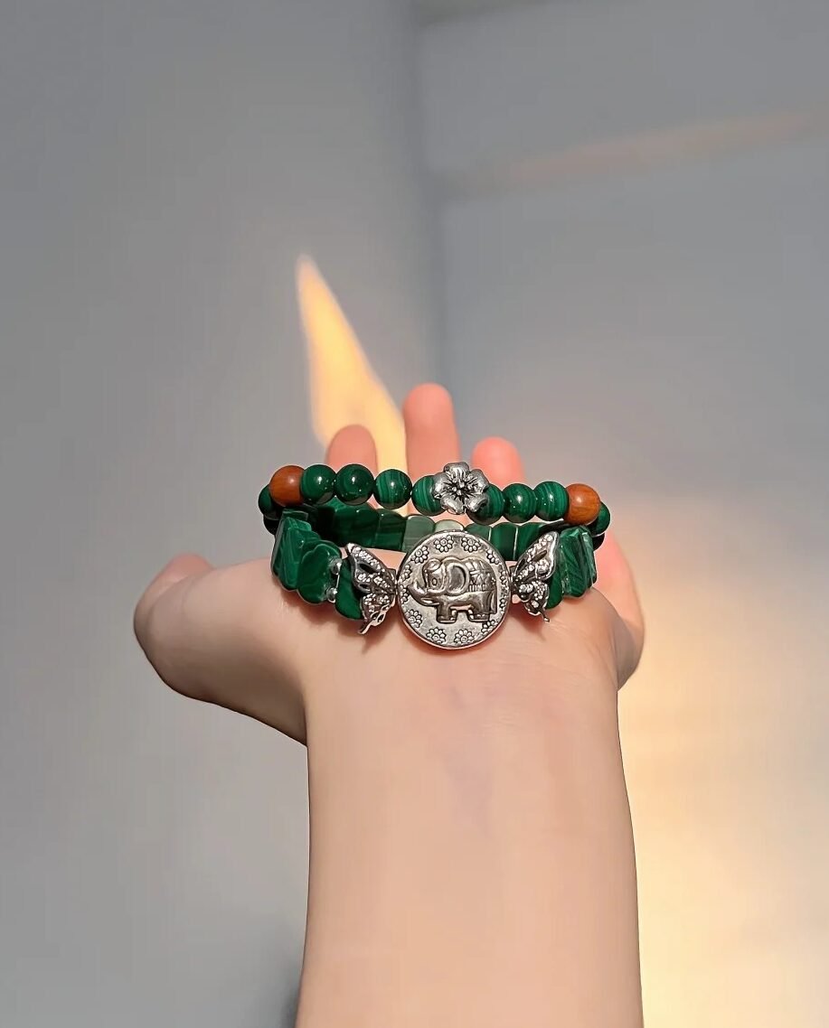Malachite bracelet against fire background, green beads vs silver, wood-fire-metal energy hides mystery