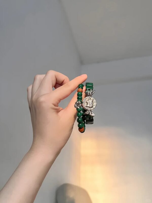 Showing silver elephant charm on malachite bracelet, green beads, red agate & silver twist, wood-fire-metal energy gathers wealth