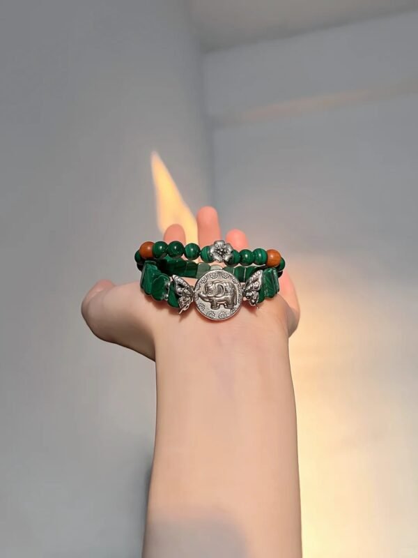 Malachite bracelet against fire background, green beads match silver, wood-fire-metal energy holds mystery