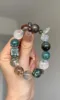 Hands Holding Metal-Water-Wood Bracelet, Green Dragon Crystal & Silver Rutilated Quartz Weave, Wood-Water-Metal Resonance Manifestation