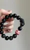 Detail of Obsidian Bracelet, Pixiu Carving & Rhodochrosite, Earth-Fire Protection