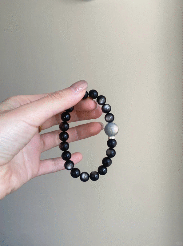 Close-Up of 8mm Silver Obsidian Bracelet, Silver Sheen Reveals Water Energy Code