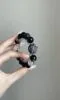 Holding Silver Obsidian × Clear Quartz Bracelet, Black-Silver Glow Hides Letting-Go Code