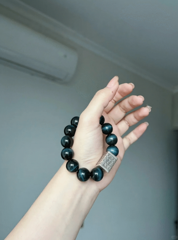 Holding Lightning Blue Tiger's Eye Bracelet, Flash Streaks Reveal Power Code