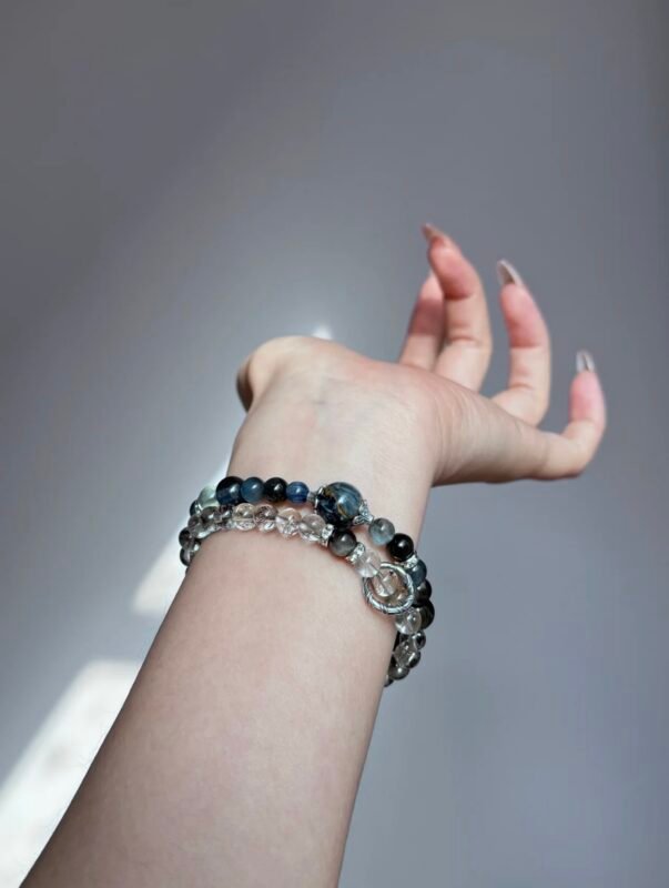 Hand Wearing Layered Blue Crystal Bracelet (Pietersite, Aquamarine, Kyanite), Water-Metal Energy Awakens Inspiration