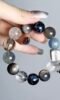 Hand Displaying Earth 2.0 Blue Crystal Bracelet (Kyanite, Aquamarine), Water-Metal Energy Awakens Cosmic Connection