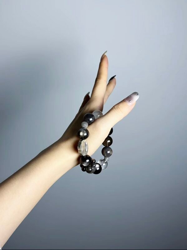 Hand Displaying Black Hole Crystal Bracelet (Black Flash Aquamarine, Silver Obsidian), Water-Metal-Earth Energy Awakens Cosmic Gravity