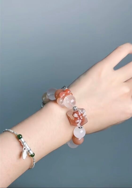 Hand Displaying Xiwei Cherry Blossom Agate Crystal Bracelet (Orange Moonstone, Blue Moonstone), Earth-Metal-Water Energy Awakens Morning Light