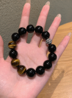 Hand Laying Out Bracelet, Black Obsidian & Yellow Tiger’s Eye Symbiosis Shows Power Balance