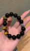 Hand Displaying 12mm Black Obsidian & Yellow Tiger’s Eye Bracelet, Water-Metal-Earth Energy Clashes Protection & Courage Field