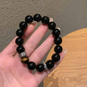Hand Displaying 10mm Black Obsidian & Yellow Tiger’s Eye Bracelet, Water-Metal-Earth Energy Weaves Courage Field