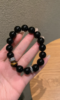 Hand Displaying 10mm Black Obsidian & Yellow Tiger’s Eye Bracelet, Water-Metal-Earth Energy Weaves Courage Field