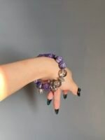 Hand Displaying Bracelet Layers, Metal Veins Seal Energy Cycle