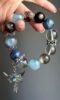 Close-Up of Multi-Gem Bracelet, Spiritual Blade In Water-Metal