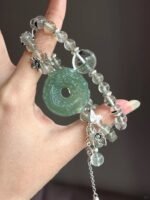 Hand-Showing Green Rutilated Accent Bead, Vitality Codes In Wood Veins