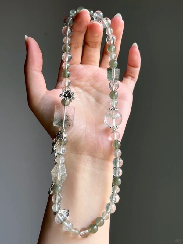 Hand-Showing Green Rutilated Accent Bead, Vitality Codes In Wood Veins