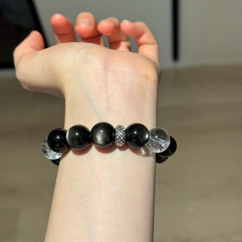 Displaying Silver Obsidian Bracelet Details On Hand, Clear Quartz Cube’s Metal Frequency Locking