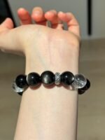 Displaying Silver Obsidian Bracelet Details On Hand, Clear Quartz Cube’s Metal Frequency Locking
