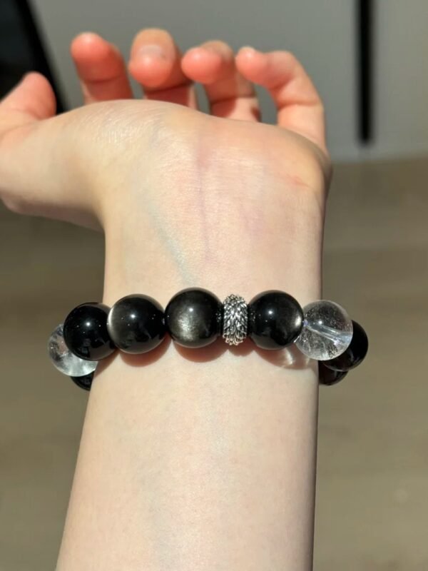 Displaying Silver Obsidian Bracelet Details On Hand, Clear Quartz Cube’s Metal Frequency Locking
