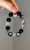 Holding Silver Obsidian Bracelet, Silver Demon-Slaying Pestle & Chrome Hearts Protective Energy Awakening