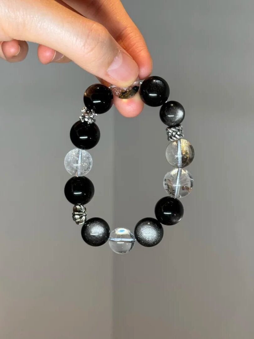 Holding Silver Obsidian Bracelet, Silver Demon-Slaying Pestle & Chrome Hearts Protective Energy Awakening