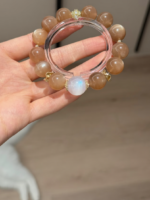 Holding 13mm Orange Moonstone (Sunstone) & 14.2mm Blue Moonstone Bracelet With Silver-Gold Accents, Fire-Water-Metal Energies Intertwine