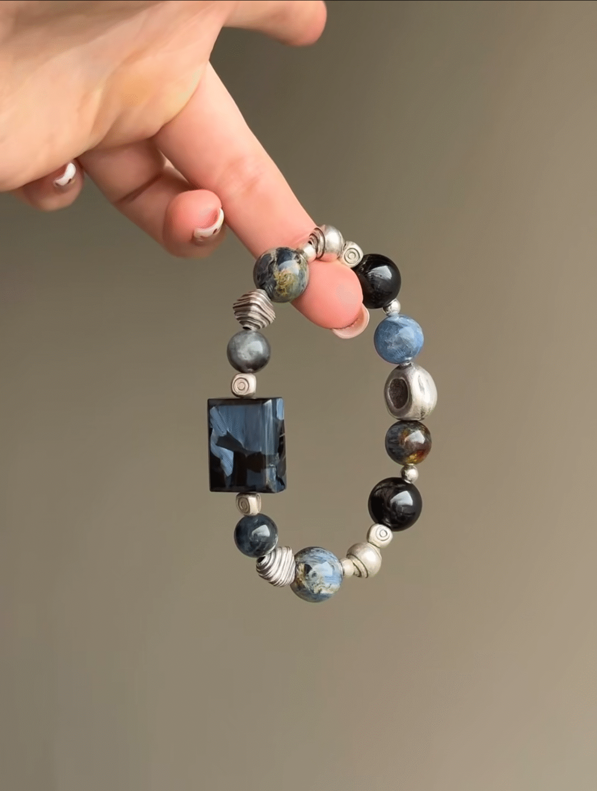 Holding Pietersite Bracelet, Silver’s Metal Energy Locking