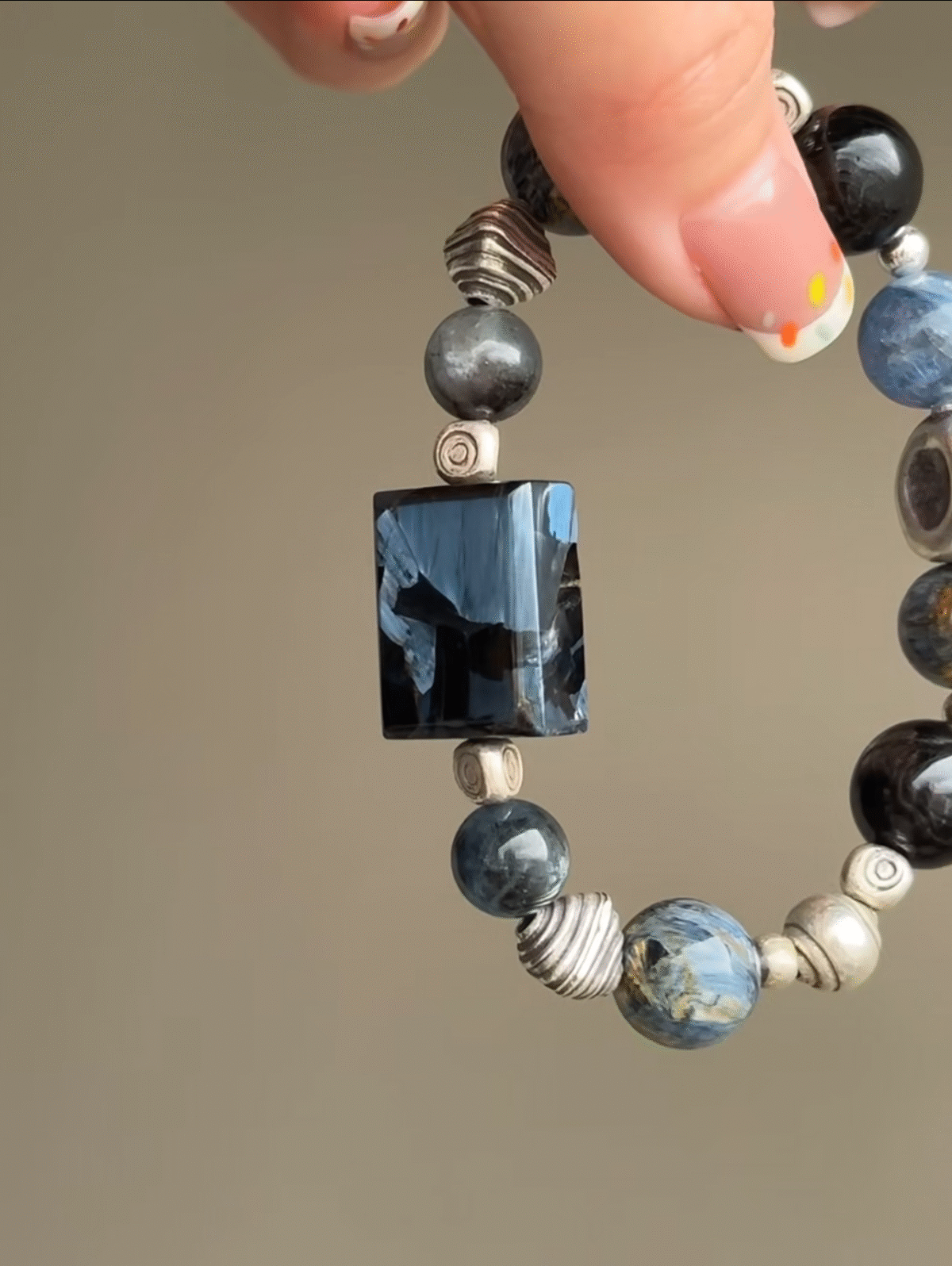 Holding Pietersite Bracelet, Amulet’s Fire Energy Blast