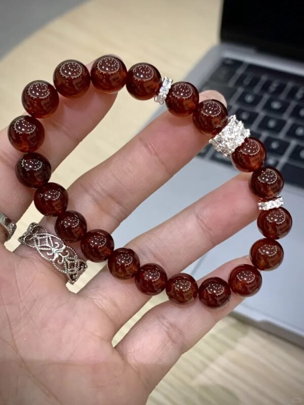 Holding 10mm Garnet Bracelet, Silver Details’ Metal Accent